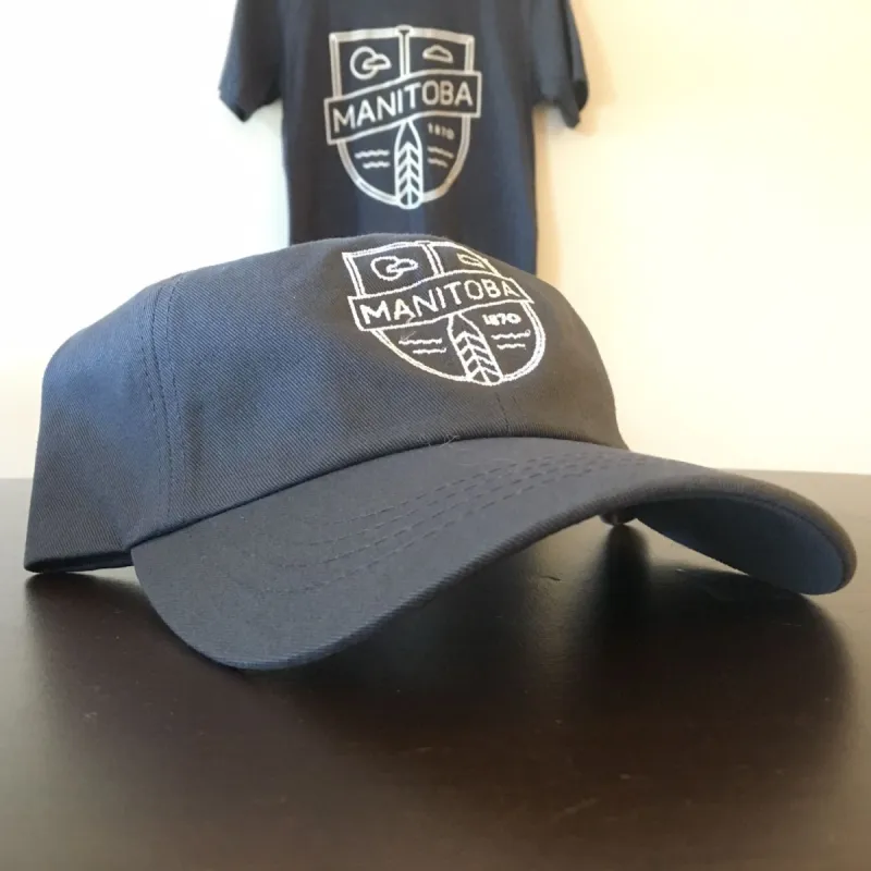 MB Cottage Dad Hat | White on Charcoal sold by We Heart Winnipeg