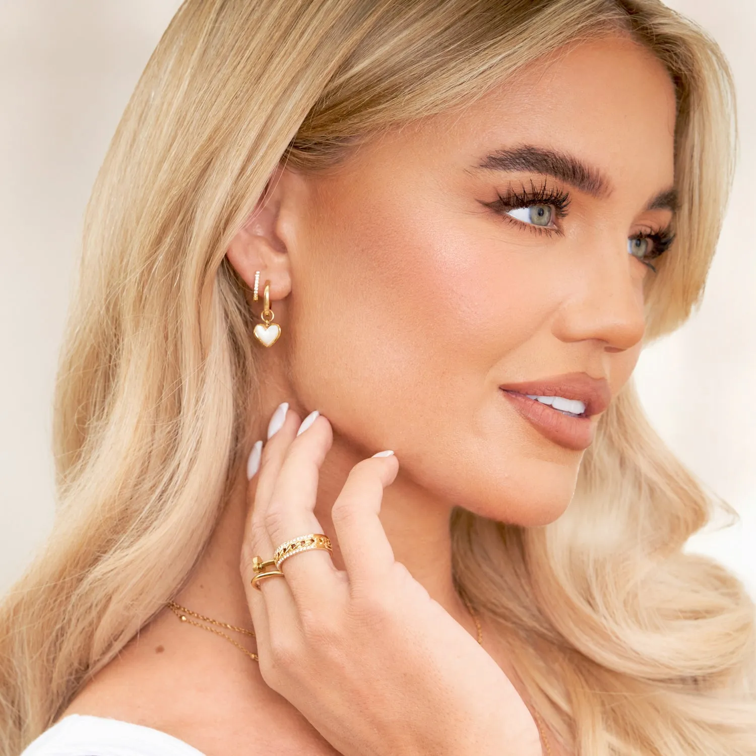 White Quartz Heart Huggie Earrings (Gold) sold by Abbott Lyon product image thumbnail 5